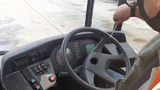 Photo of a bus steering wheel being swabbed
